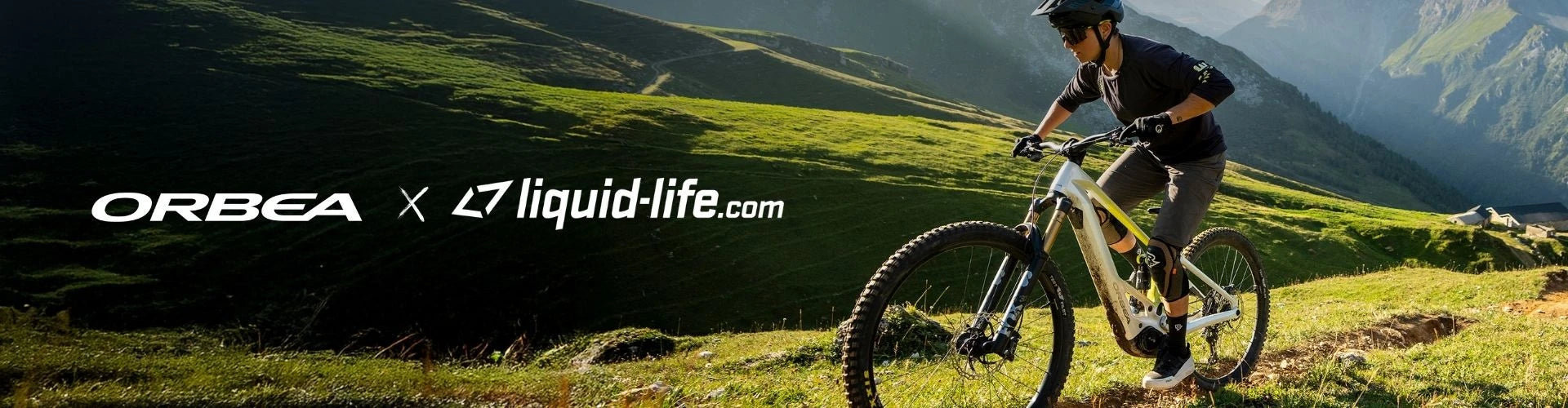 Banner: Orbea Testevent bei Liquid-Life.de in Brilon - Mann fährt auf Orbea Wild E-MTB eine berigische Landschaft