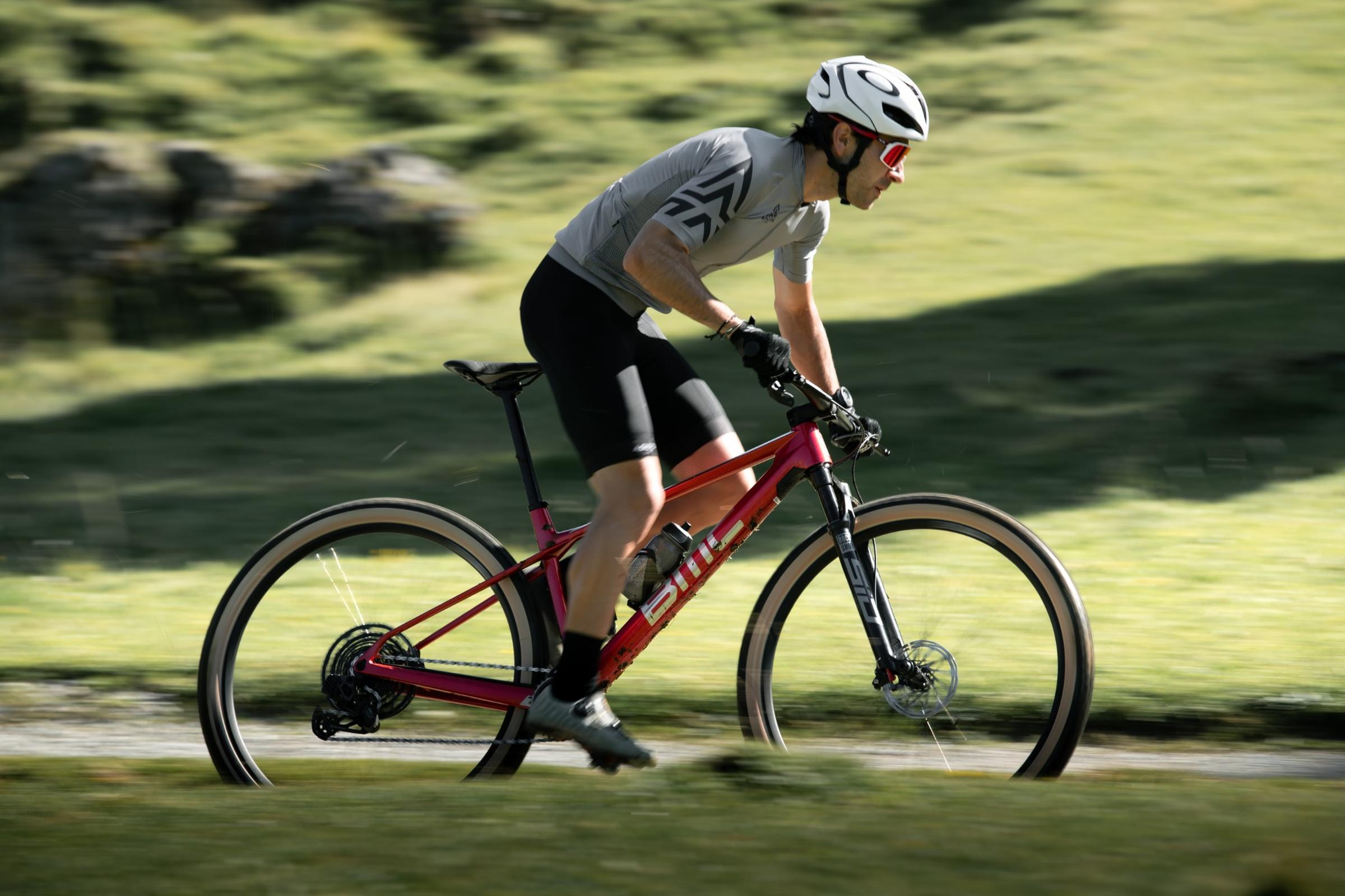 Radfahrer auf einem BMC Mountainbike auf Waldweg, mit Helm und Sportkleidung, geeignet für Outdoor-Abenteuer.