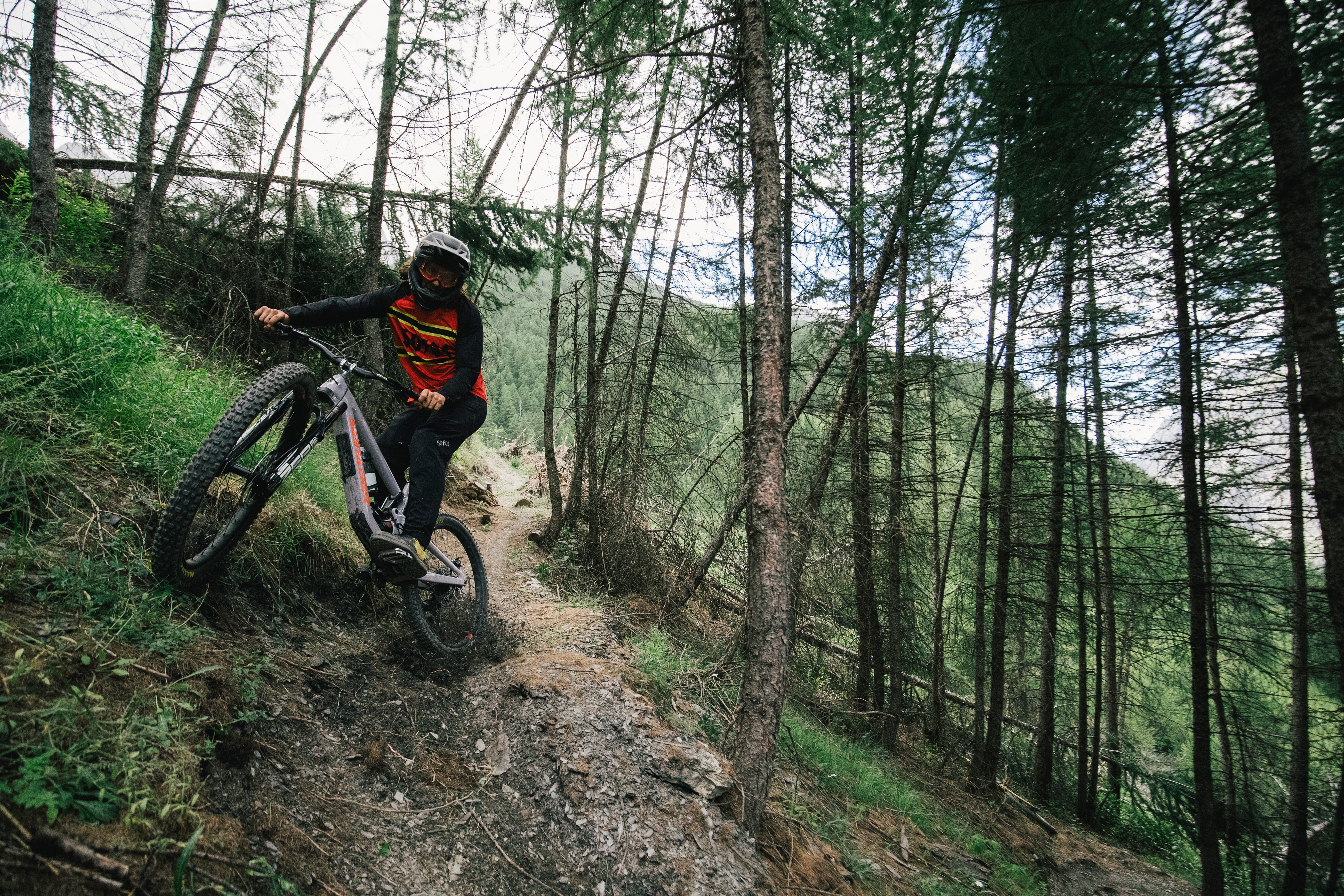 Mountainbiker auf Santa Cruz Fahrrad fährt steilen Waldpfad hinunter, geeignet für Abenteuersportler und Mountainbike-Fans.